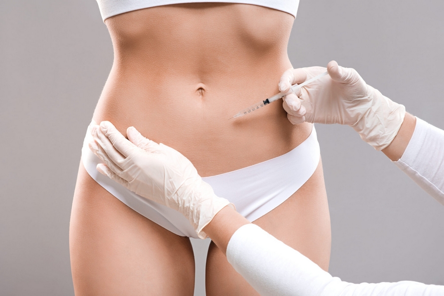 Slim lady having lipolysis treatment at beauty salon